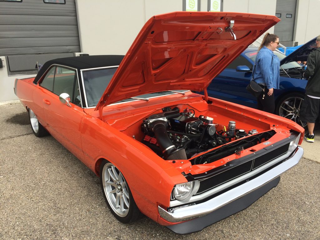 supercharged dodge dart with a gen 3 hemi mopar engine swap at a classic car show