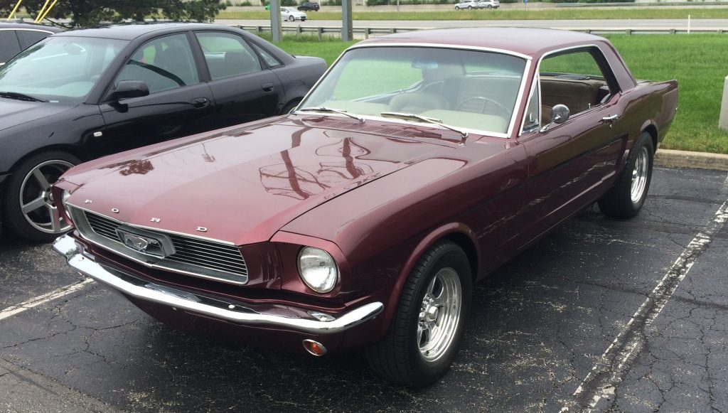 maroon ford mustang notchback at a classic car show