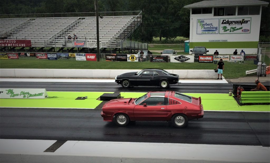 a vintage camaro drag racing a ford mustang cobra 2 at edgewater sports park near cincinnati ohio