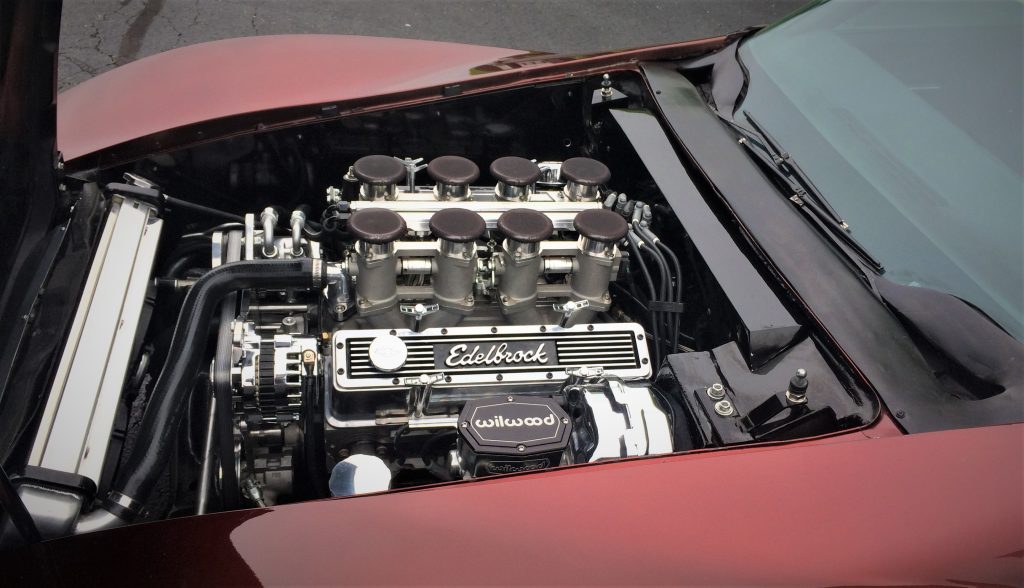 eight individual velocity stacks on a 383 stroker small block chevy v8 engine within a custom 1971 chevy corvette stingray