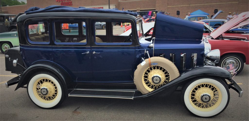 blue 1932 chevy sedan at a classic antique automobile car show