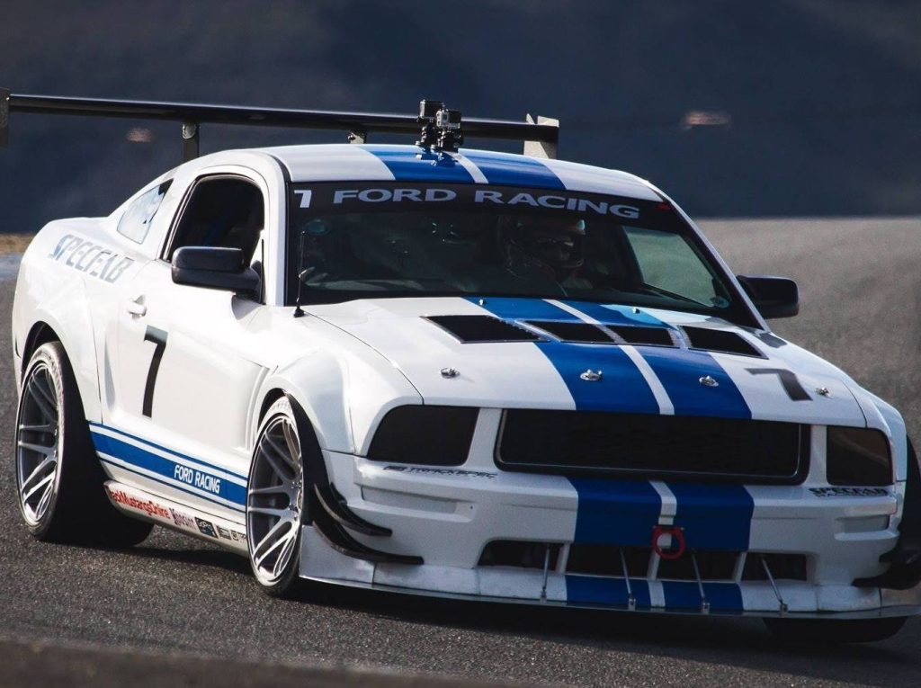 a picture of a highly modified s197 ford mustang on a race track