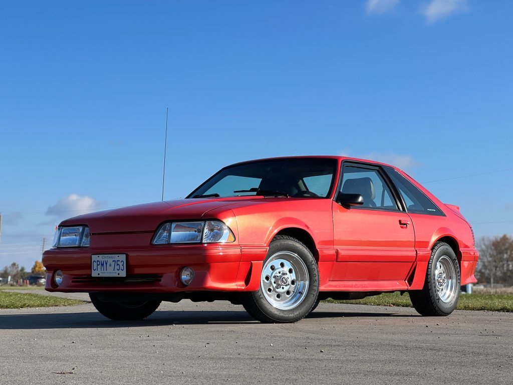a red ford mustang fox body 5.0 liter