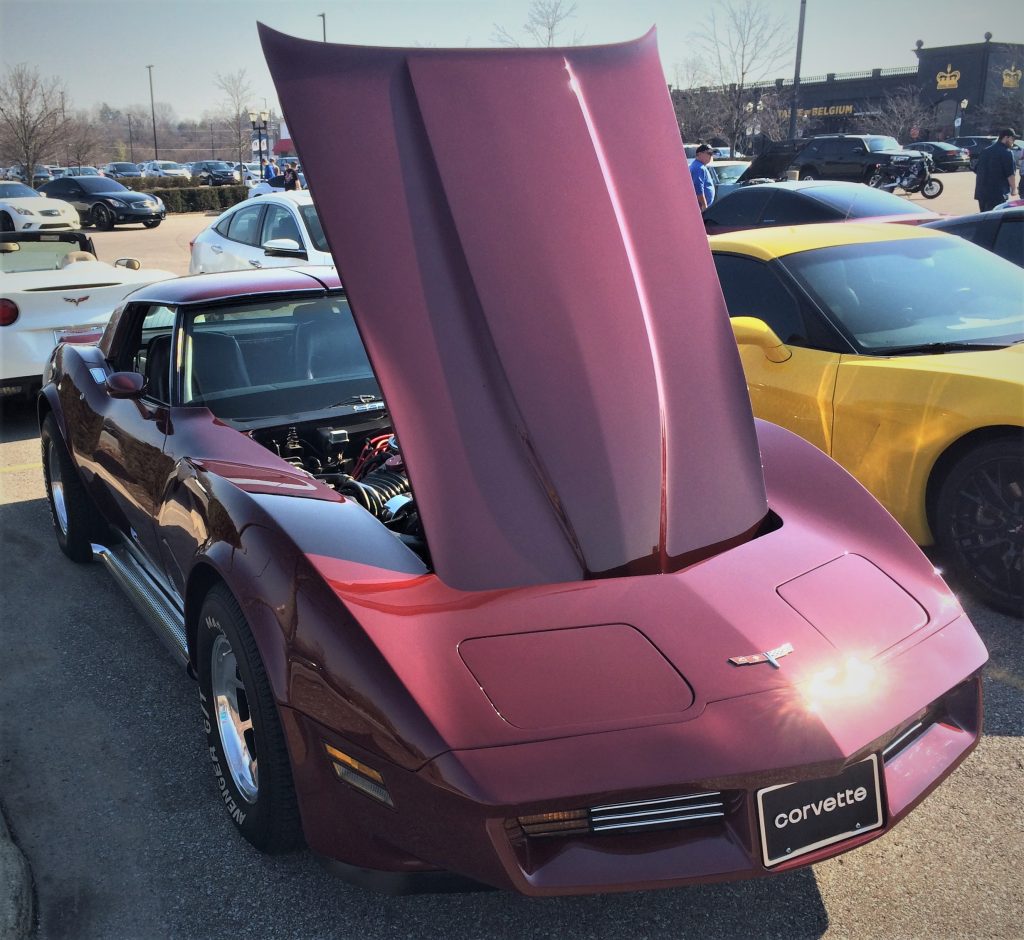 late c3 corvette at car show with its hood up