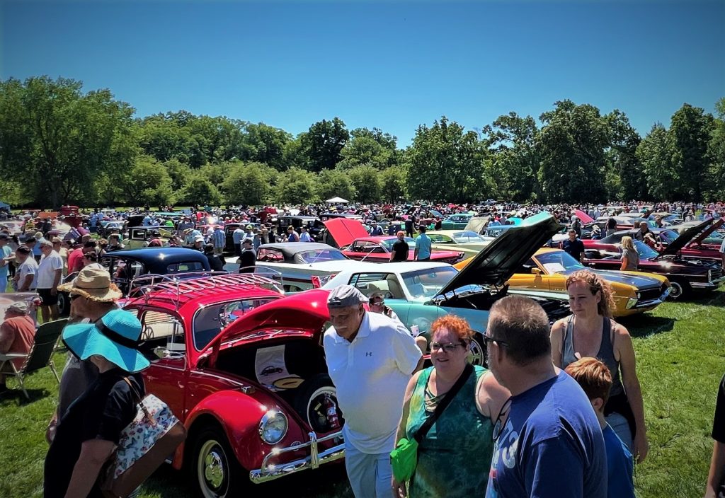 crowd of cars and families at classic vehicle show