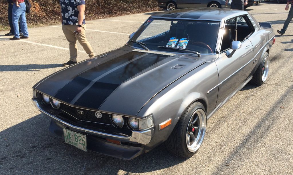 front grille and hood of a silver 1977 toyota celica gt sports car at a car show