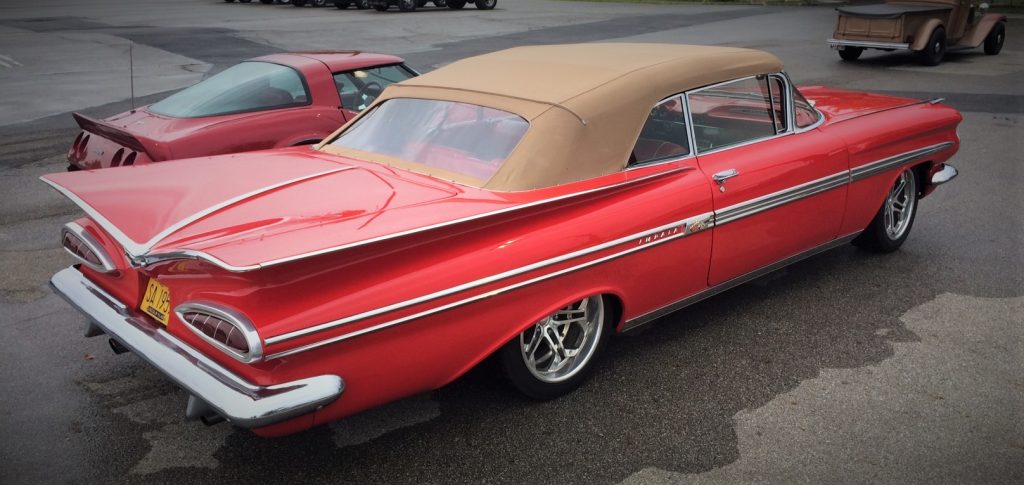 a red 1959 chevy impala convertible