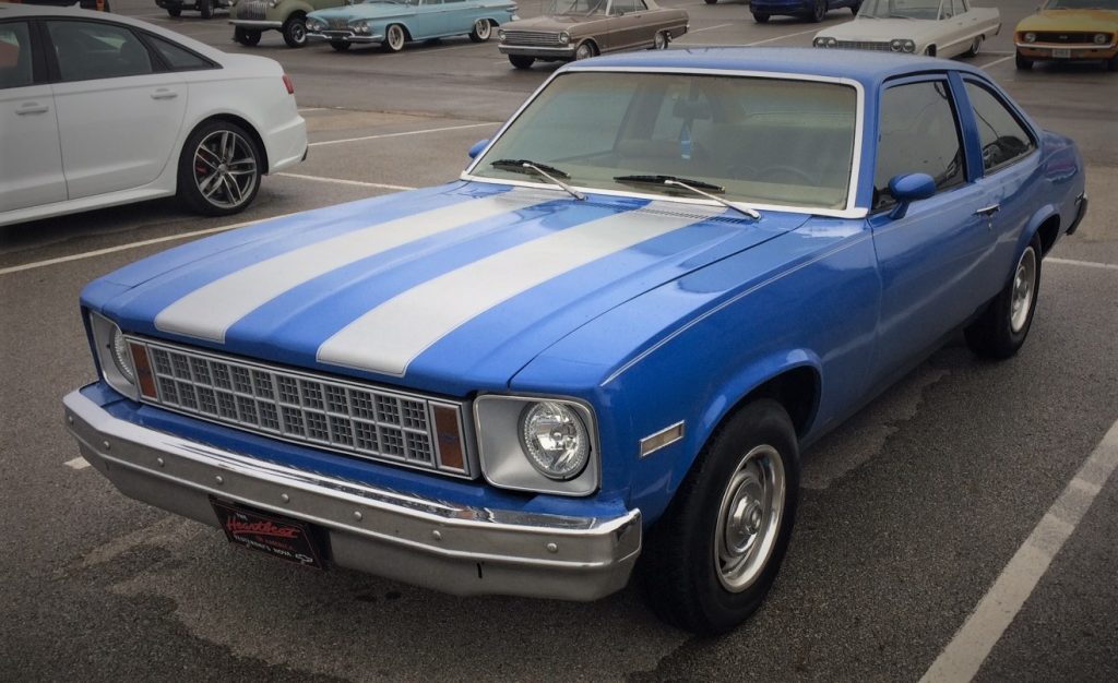 a 1970s era chevy nova, blue with silver racing stripes