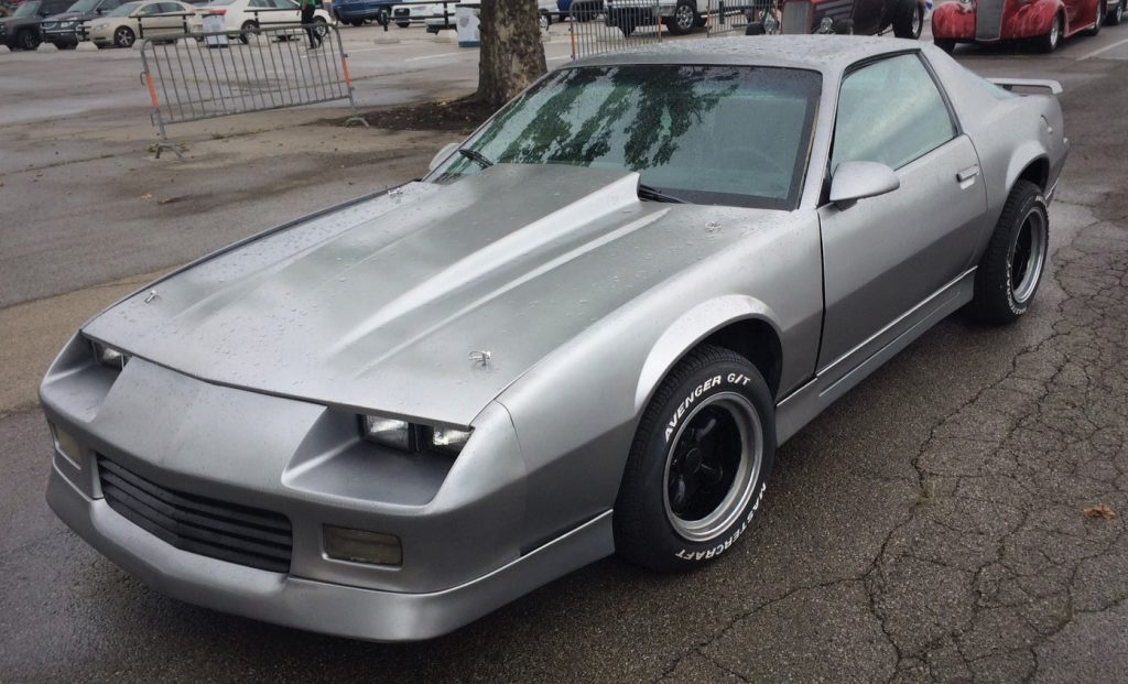 a silver third gen chevy camaro coupe with cowl induction hood