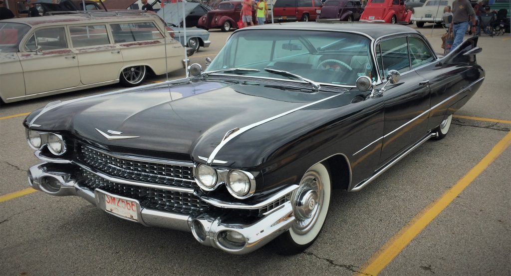 a black 1959 cadillac hardtop coupe at a car show