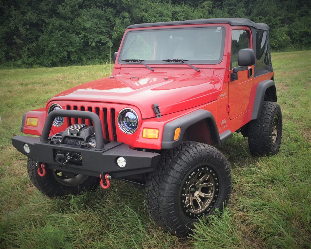 a red jeep wranlger tj with winch