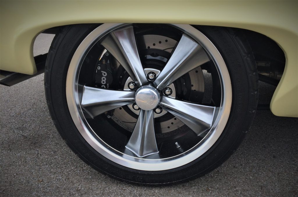 close up look of custom foose wheels on henry j hot rod