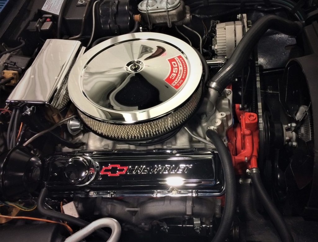 a small block 350 chevy v8 engine under the hood of a stingray corvette