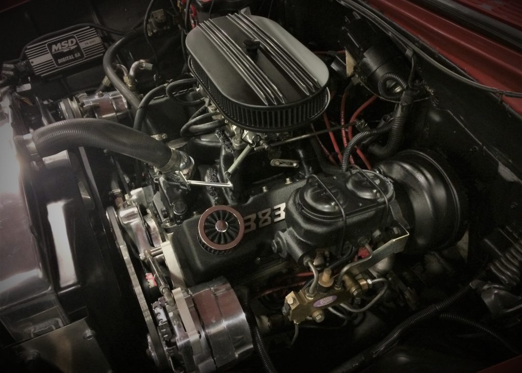 a chevy 383 stroker v8 engine under the hood of a muscle car
