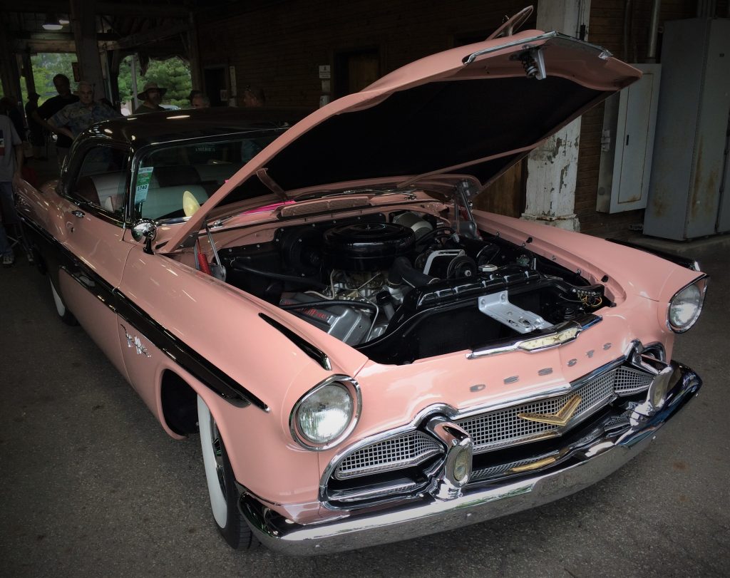 pink desoto fire flite coupe at a car show