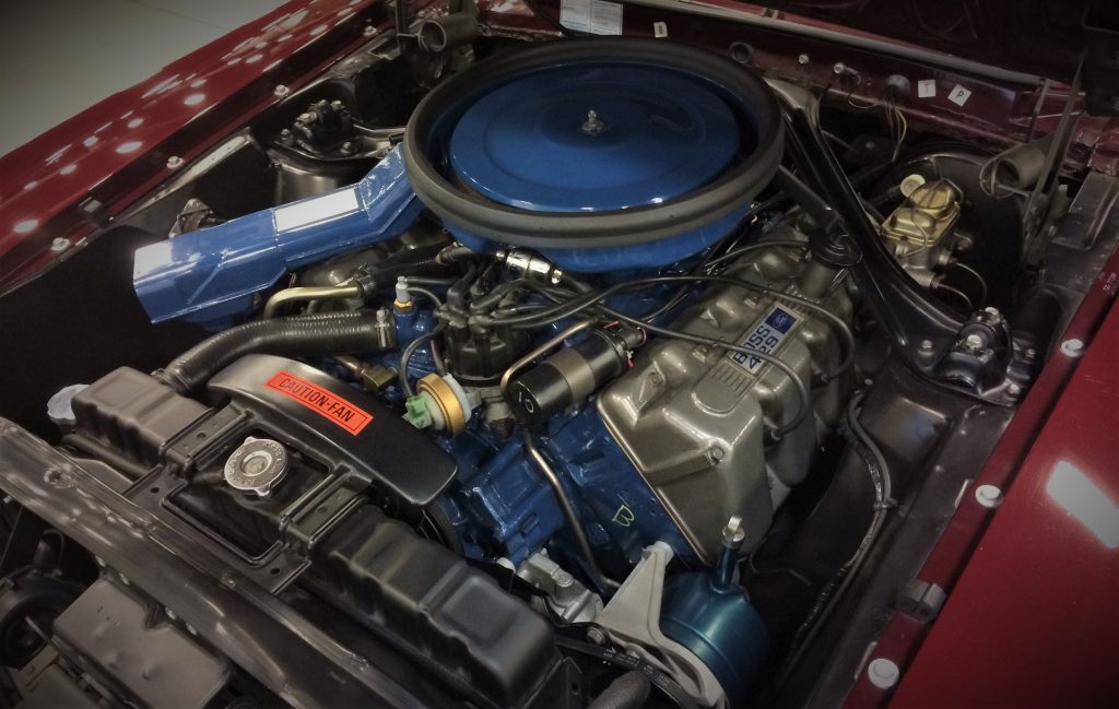 a ford boss 429 v8 engine under the hood of a classic mustang