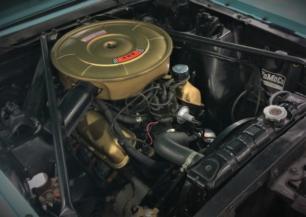 a ford 289 v8 engine in a classic car with a gold air cleaner
