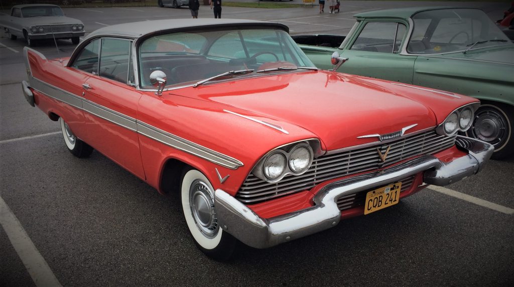 front quarter of a red 1958 plymouth fury that looks like Christine from the john carpenter movie