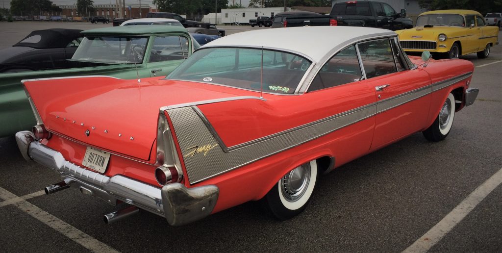 rear quarter shot of 1958 red plymouth fury that looks like the Christine car form the stephen king book