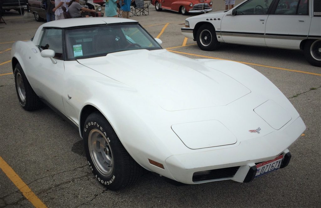 front quarter shot of a white 1979 chevy corvette parked at a car show