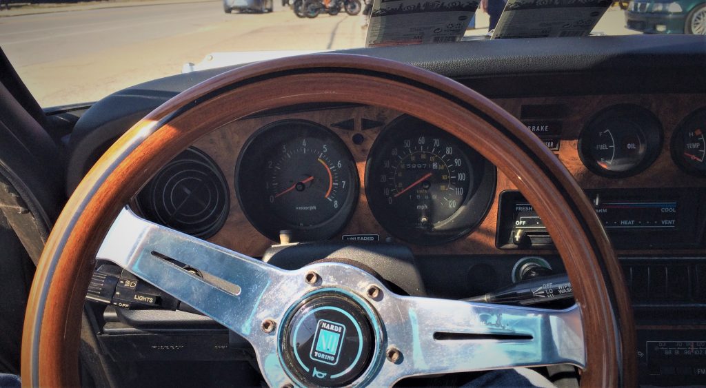 close up picture of the gauge cluster on a silver 1977 toyota celica gt sports car