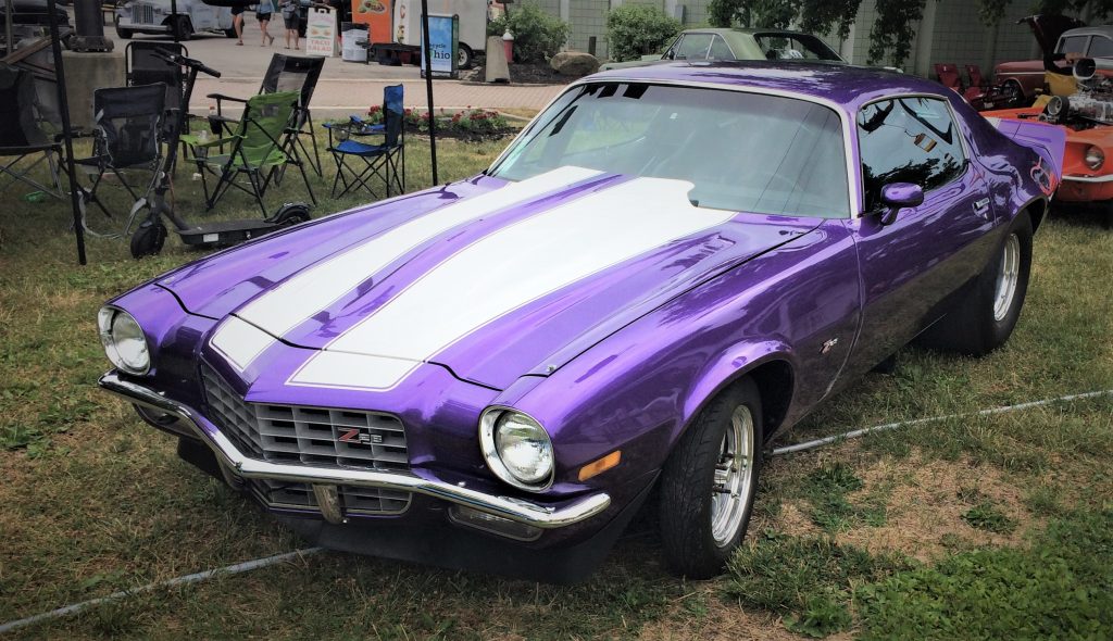 purple chevy camaro fromt he early 1970s at a classic car show
