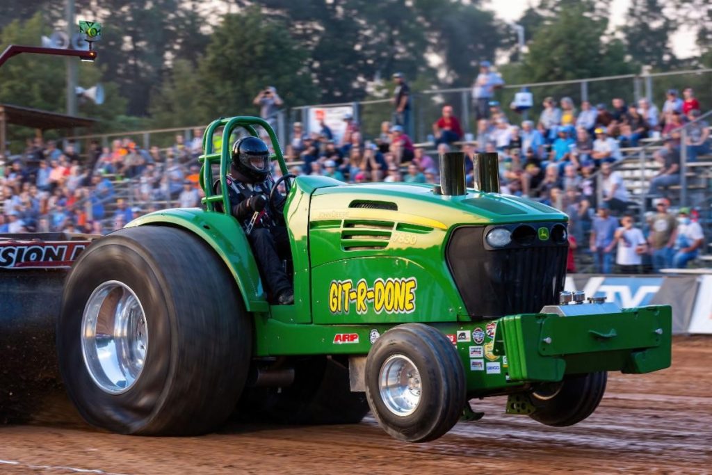 big green tractor at a tractor pull event launch