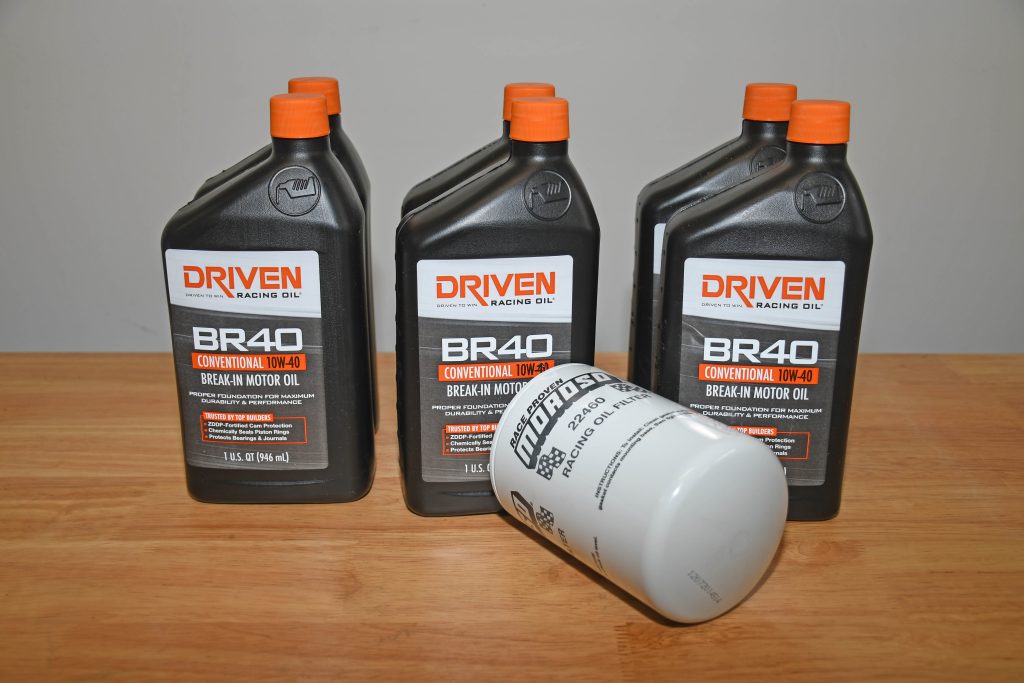six quarts of driven racing motor oil and moroso oil filter on a workbench