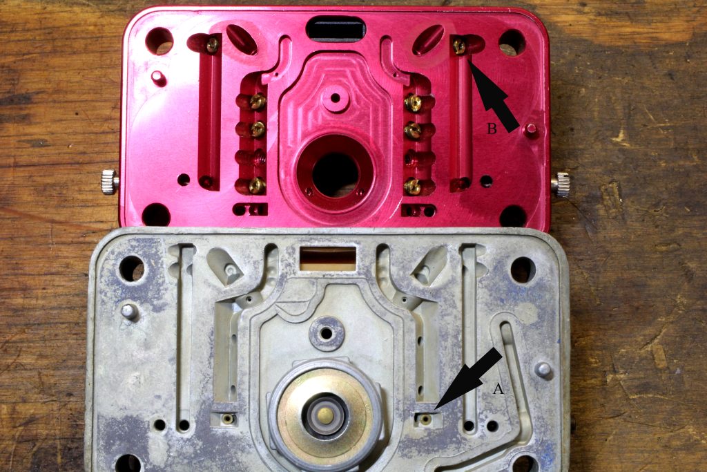 close up look at holley carburetor metering blocks on wooden table