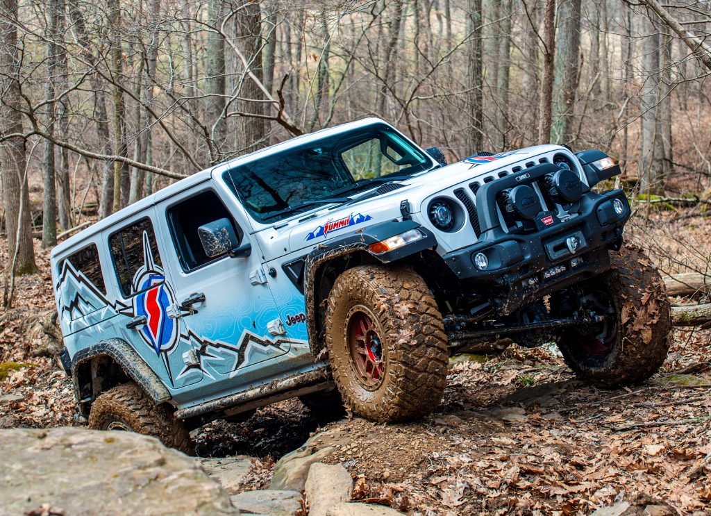 side view of jeep wrangler jl on muddy trail