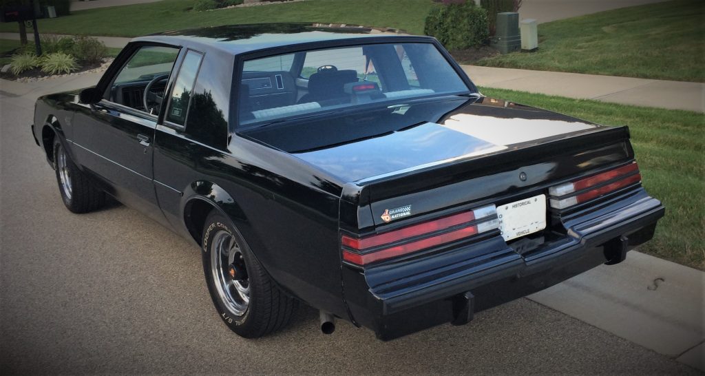 1987 buick grand national parked on a street, rear view