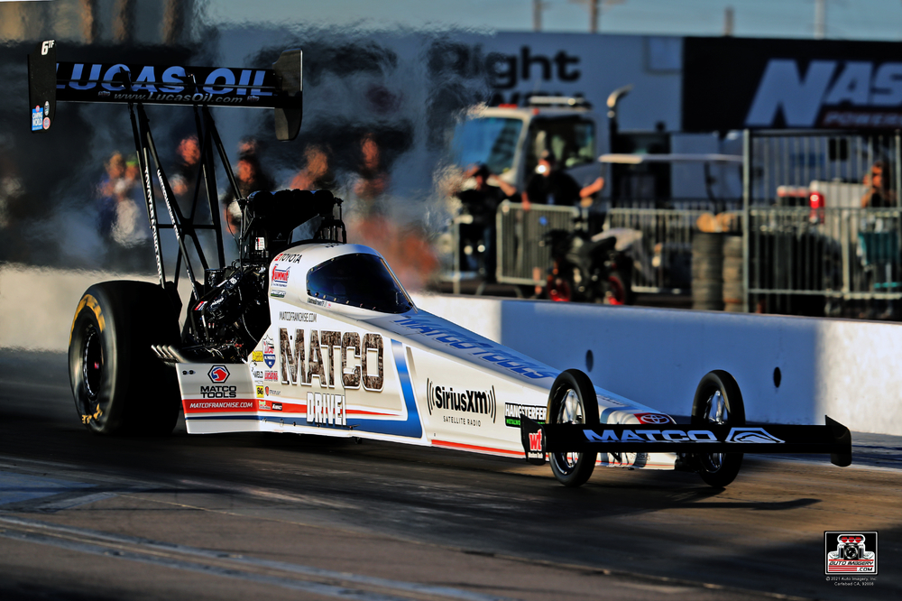 Antron Brown in top fuel dragster staging during nhra drag race