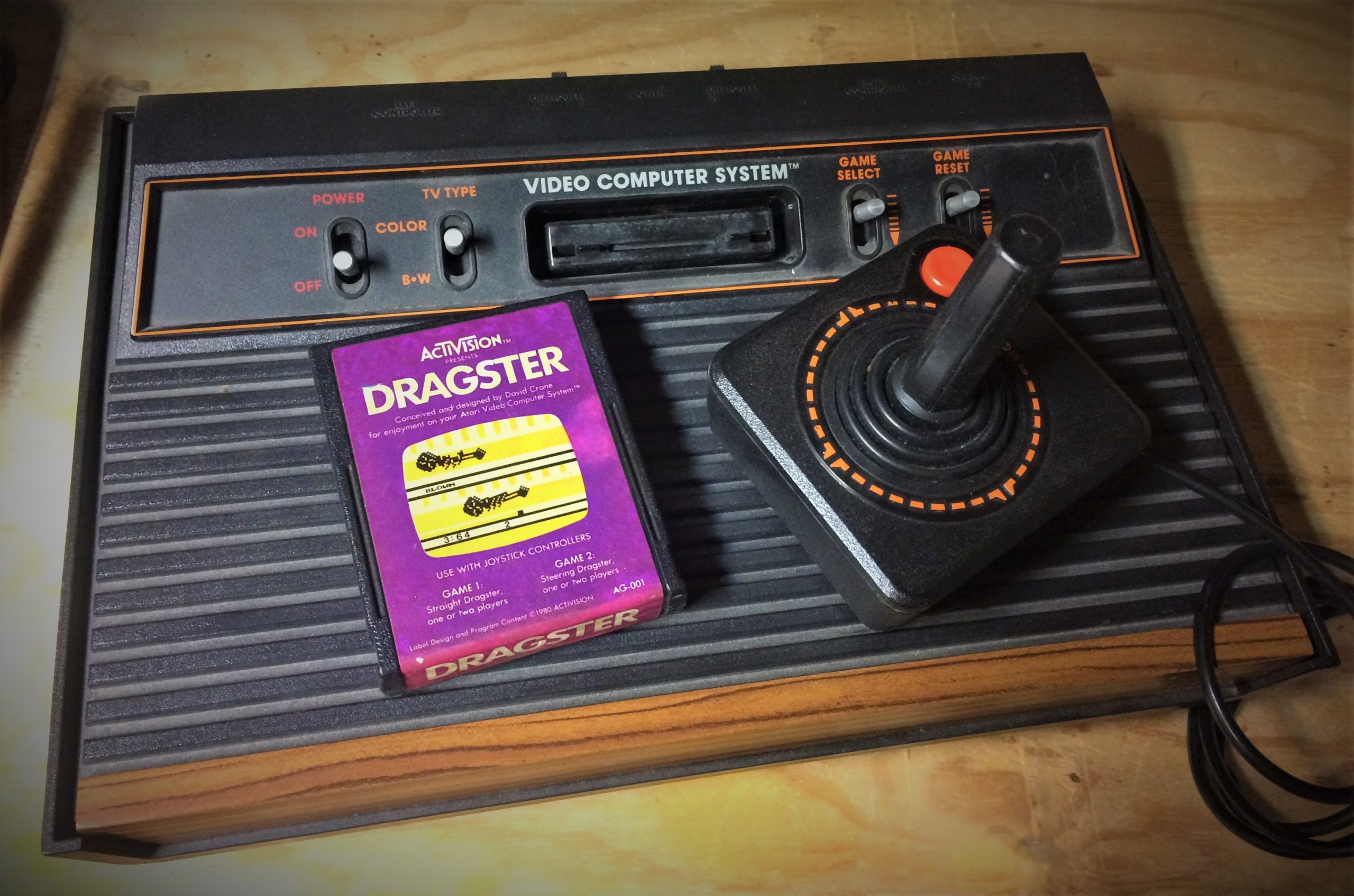 atari-2600-console-with-activision-dragster-placed-on-top-vintage-video-game-racing-scaled.jpg