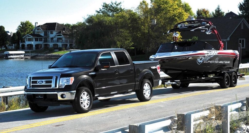ford f-150 truck towing super air nautique speed boat on trailer