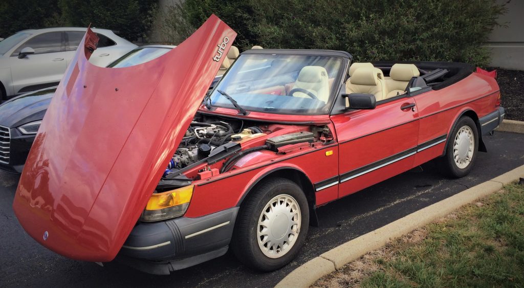 saab 900 convertible turbo coupe at a car show