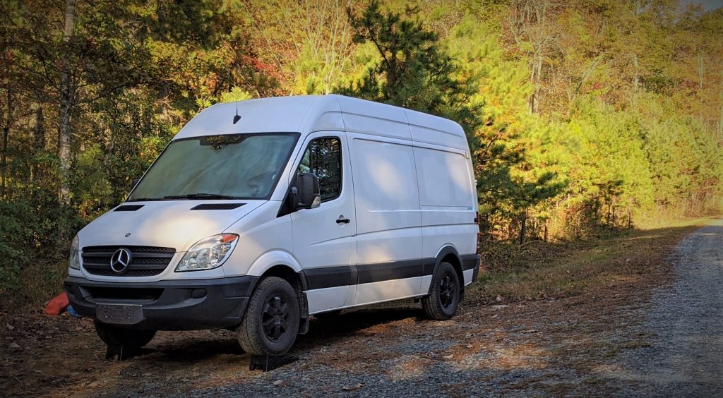 a Mercedes vanlife camping sprinter van on a trail