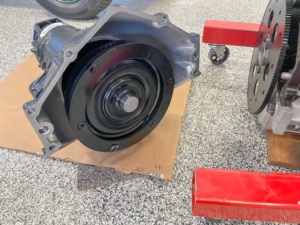 transmission bellhousing and flexplate near engine stand