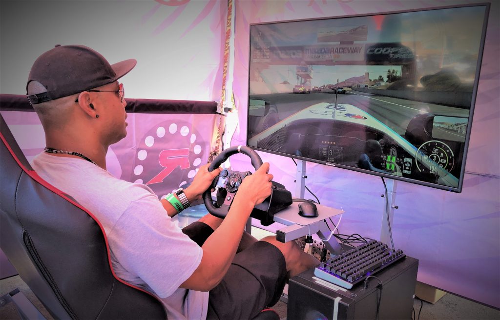 man using gtr video game racing simulator at an event