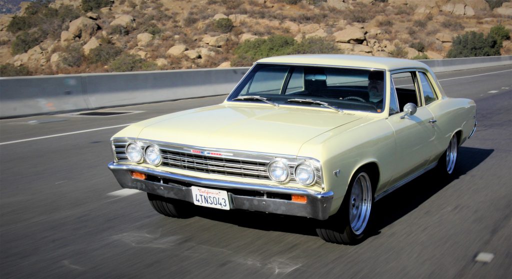 vintage chevy chevelle muscle car being driven on a highway