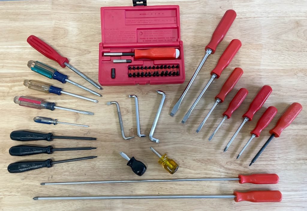 group of screwdrivers arranged on a workbench