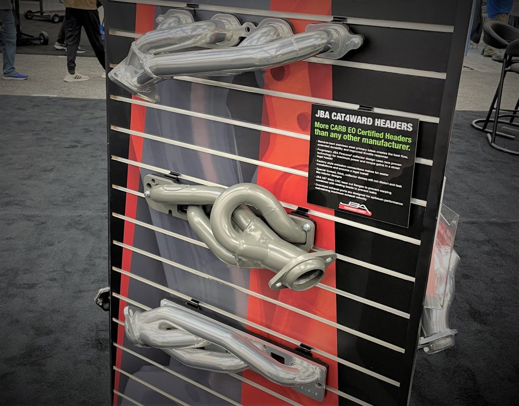 collection of exhuast headers on a trade show display board