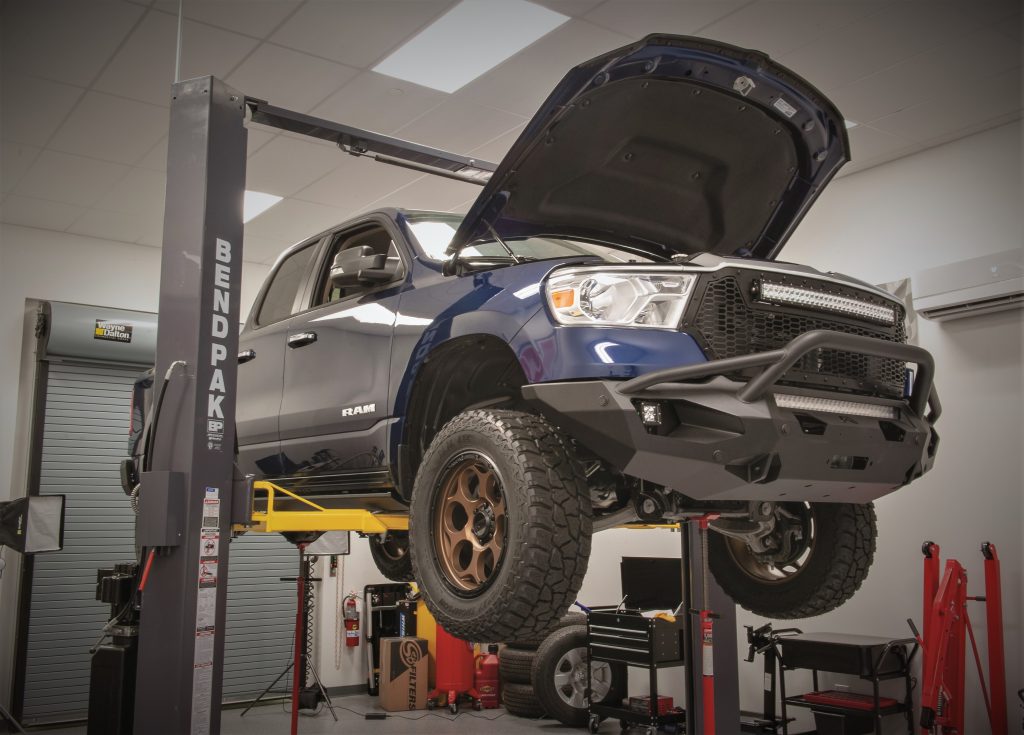 dodge ram truck on a lift in a professional shop