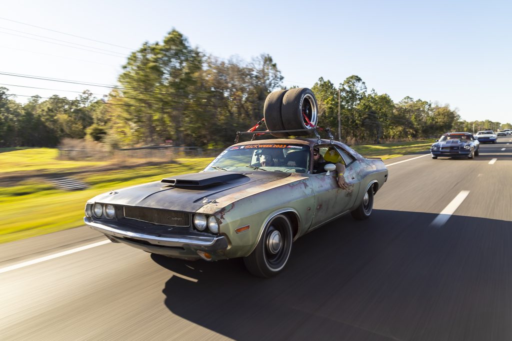 modified first gen dodge challenger on highway during sick week