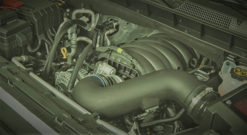 Stylized photo of a gm lt ls series engine in late model Chevy Silverado truck