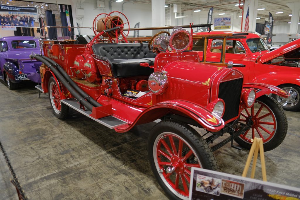 1920 Ford Model T fire truck displayed at an indoor car show
