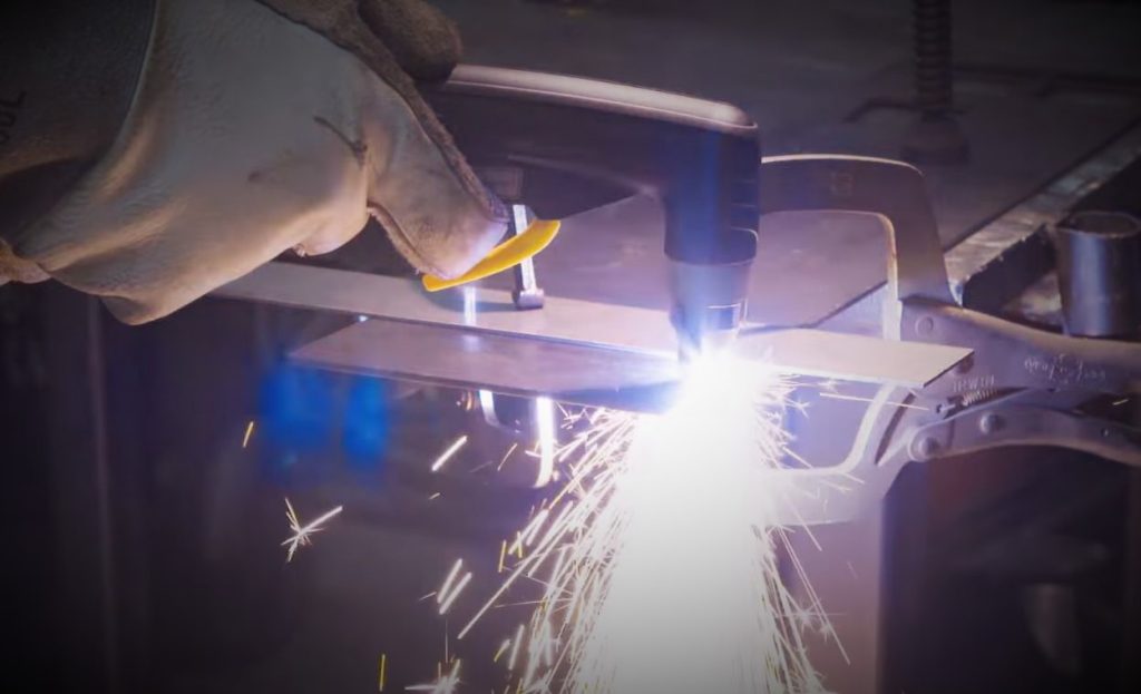 Fabricator Cutting a piece of steel with a plasma torch