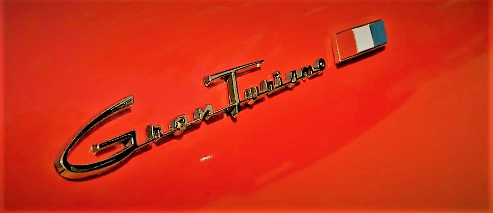 stylized photo of Gran Turismo Badge on Studbaker hawk GT red