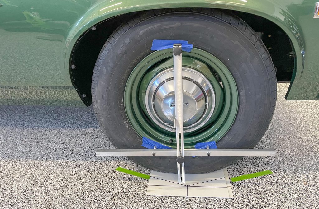 wheel alignment tool installed on a vintage chevy nova