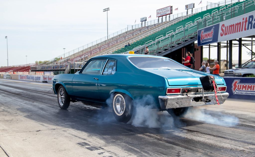 chevy nova ss drag car doing a burnout at dragstrip