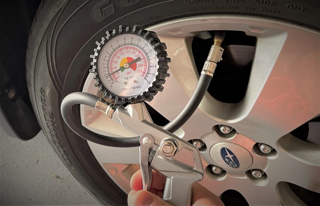 tire inflator being used on a car tire